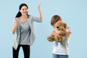 Angry mother scolding her son in living room at home Angry mother scolding her son in living room at home
